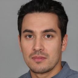 Neutral white young-adult male with short  black hair and brown eyes