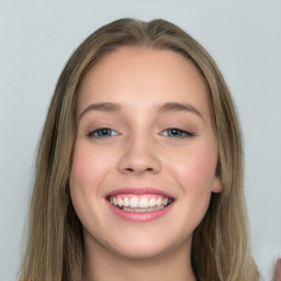 Joyful white young-adult female with long  brown hair and green eyes