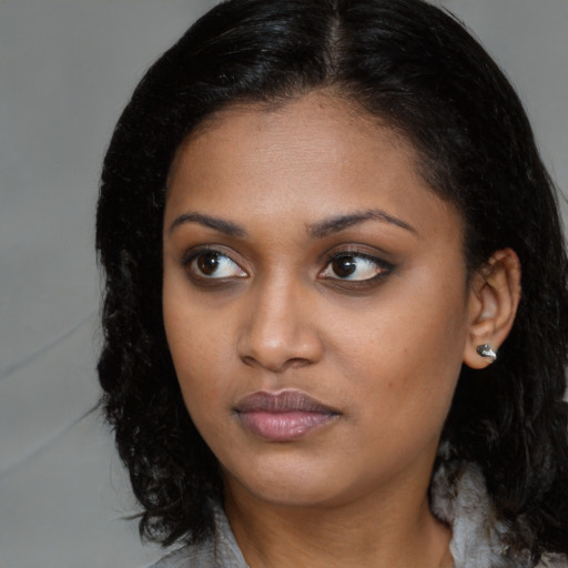 Neutral black young-adult female with long  brown hair and brown eyes