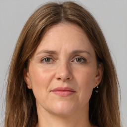 Joyful white adult female with long  brown hair and grey eyes