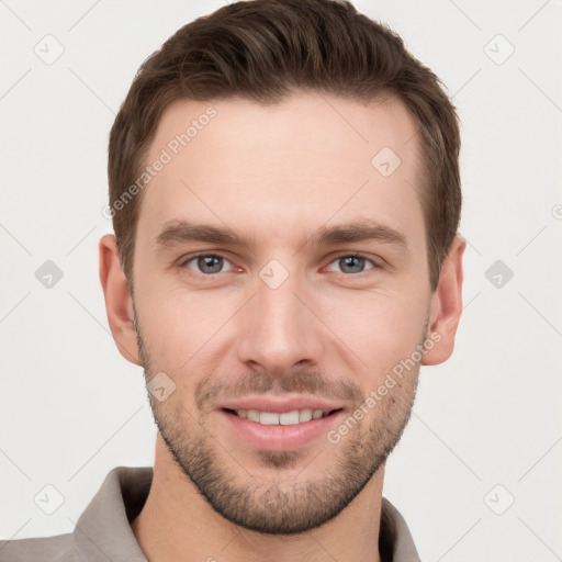 Joyful white young-adult male with short  brown hair and grey eyes