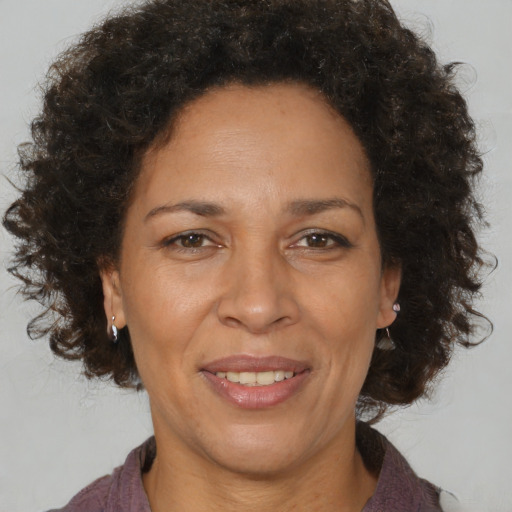 Joyful black adult female with medium  brown hair and brown eyes