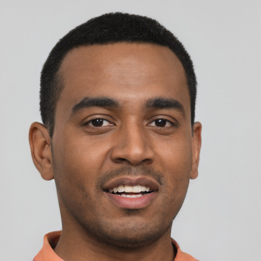 Joyful black young-adult male with short  black hair and brown eyes