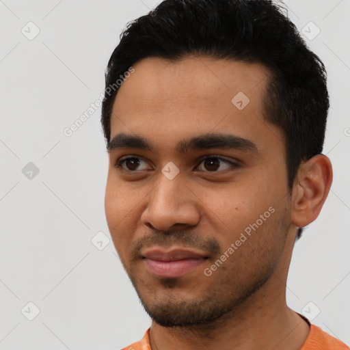 Joyful latino young-adult male with short  black hair and brown eyes