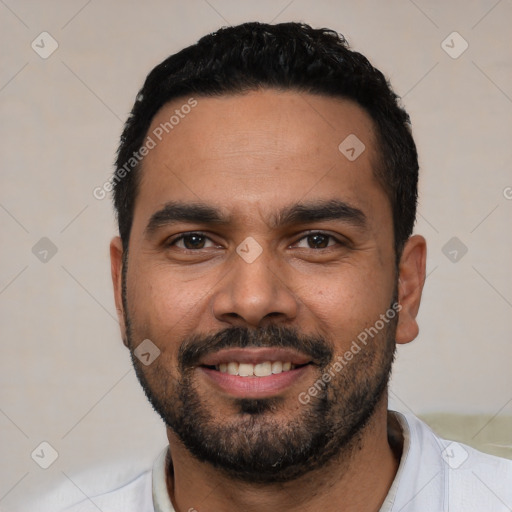 Joyful latino young-adult male with short  black hair and brown eyes