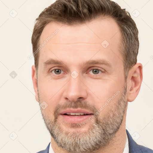 Joyful white adult male with short  brown hair and grey eyes