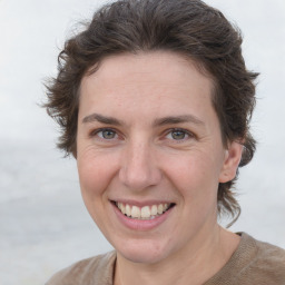 Joyful white adult female with short  brown hair and grey eyes