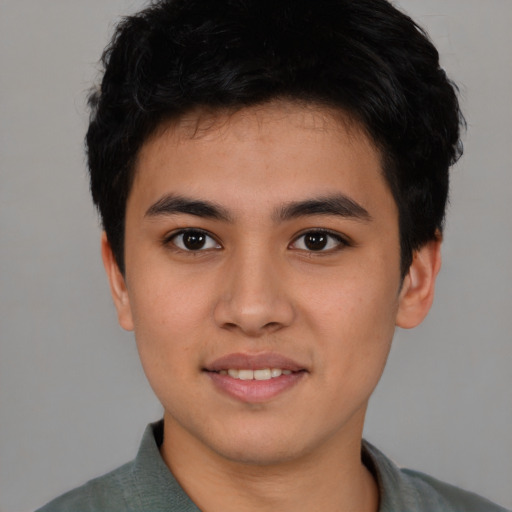 Joyful asian young-adult male with short  brown hair and brown eyes