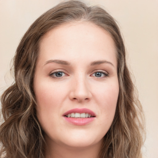 Joyful white young-adult female with long  brown hair and green eyes