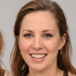 Joyful white adult female with long  brown hair and brown eyes