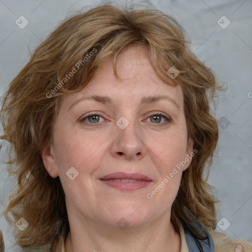 Joyful white adult female with medium  brown hair and blue eyes