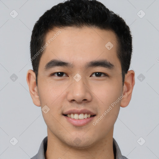 Joyful latino young-adult male with short  black hair and brown eyes