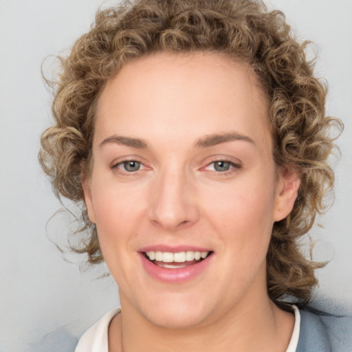 Joyful white young-adult female with medium  brown hair and green eyes