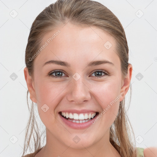 Joyful white young-adult female with long  brown hair and grey eyes