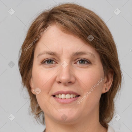 Joyful white adult female with medium  brown hair and grey eyes