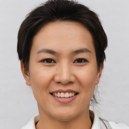 Joyful asian young-adult female with short  brown hair and brown eyes