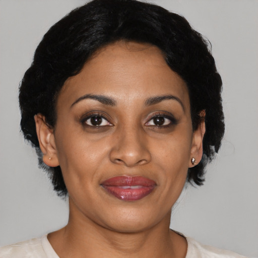 Joyful latino adult female with short  black hair and brown eyes