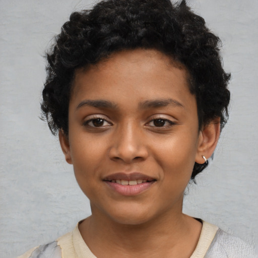 Joyful latino child female with short  black hair and brown eyes