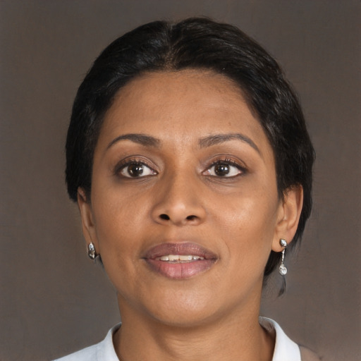 Joyful black adult female with medium  brown hair and brown eyes