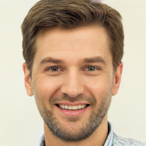 Joyful white young-adult male with short  brown hair and brown eyes