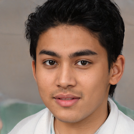 Joyful latino young-adult male with short  brown hair and brown eyes