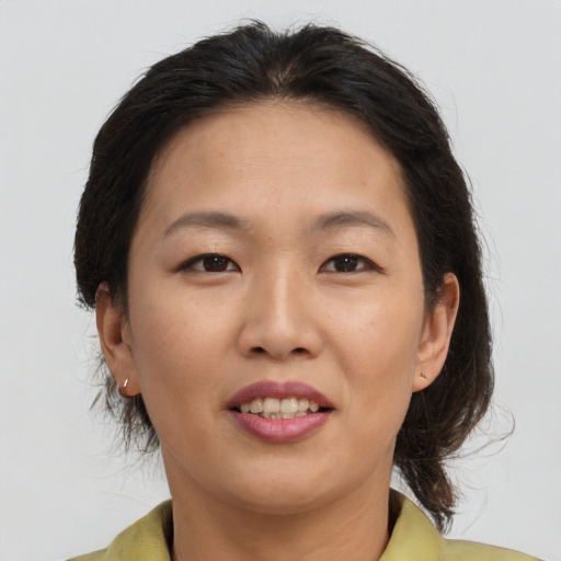 Joyful asian young-adult female with medium  brown hair and brown eyes