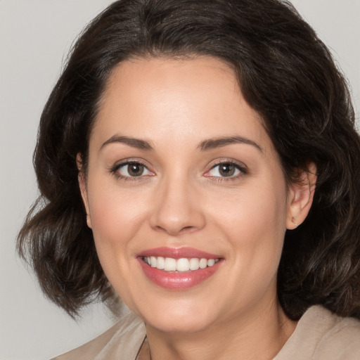 Joyful white young-adult female with medium  brown hair and brown eyes