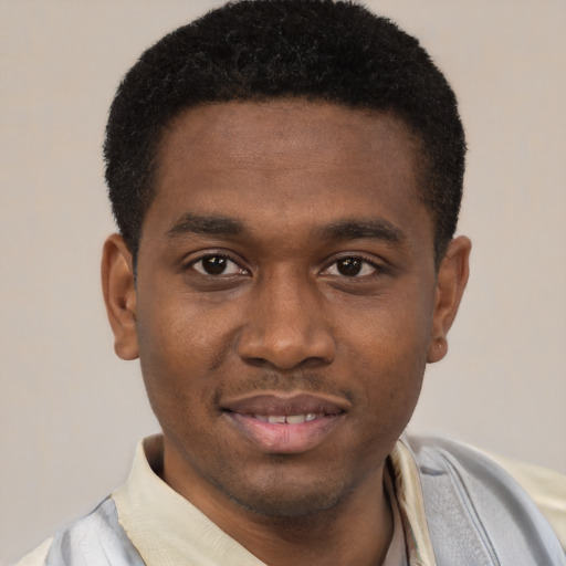 Joyful latino young-adult male with short  brown hair and brown eyes