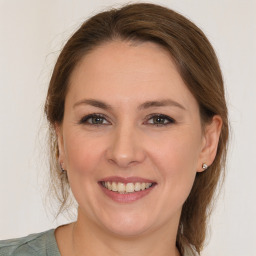 Joyful white young-adult female with medium  brown hair and grey eyes