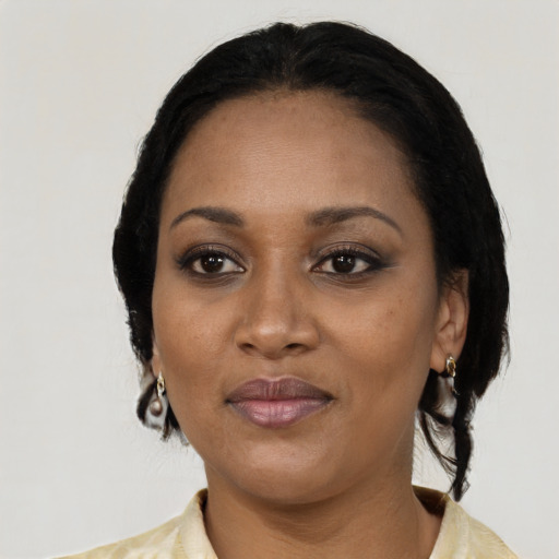 Joyful black adult female with medium  black hair and brown eyes