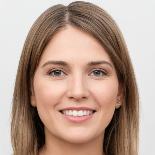 Joyful white young-adult female with long  brown hair and grey eyes