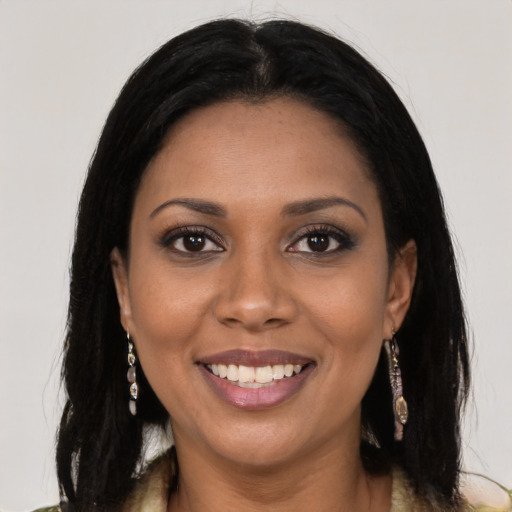 Joyful black young-adult female with long  black hair and brown eyes