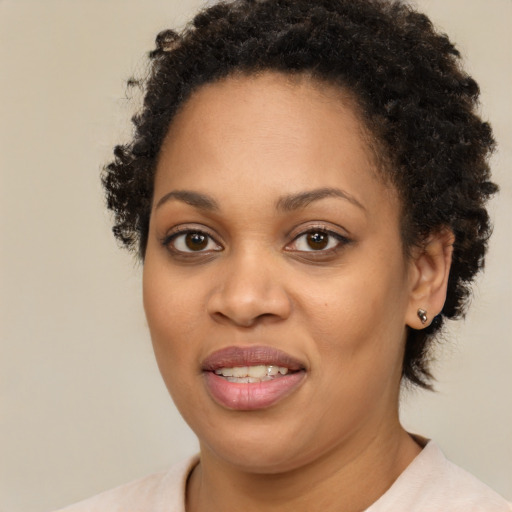 Joyful black young-adult female with short  brown hair and brown eyes