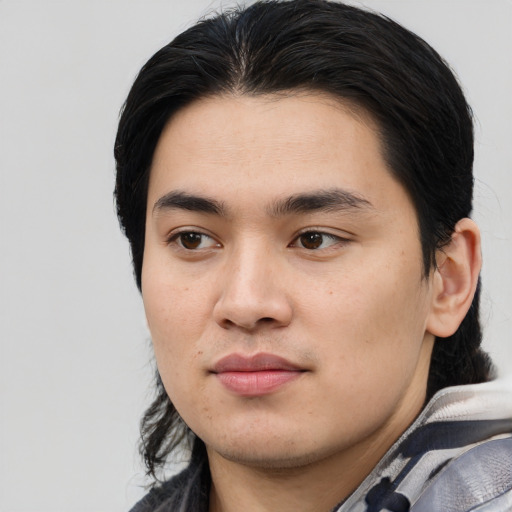 Joyful asian young-adult male with medium  black hair and brown eyes