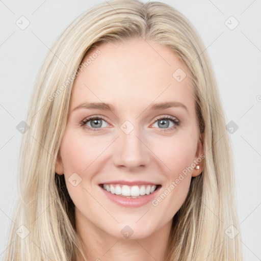 Joyful white young-adult female with long  brown hair and blue eyes