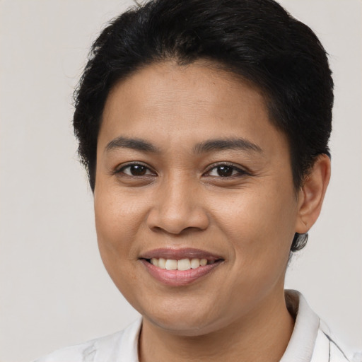 Joyful latino young-adult female with short  brown hair and brown eyes