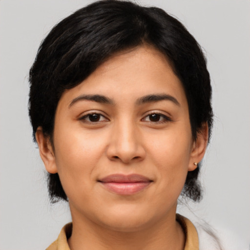 Joyful latino young-adult female with medium  black hair and brown eyes