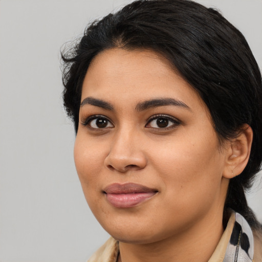 Joyful latino young-adult female with medium  black hair and brown eyes