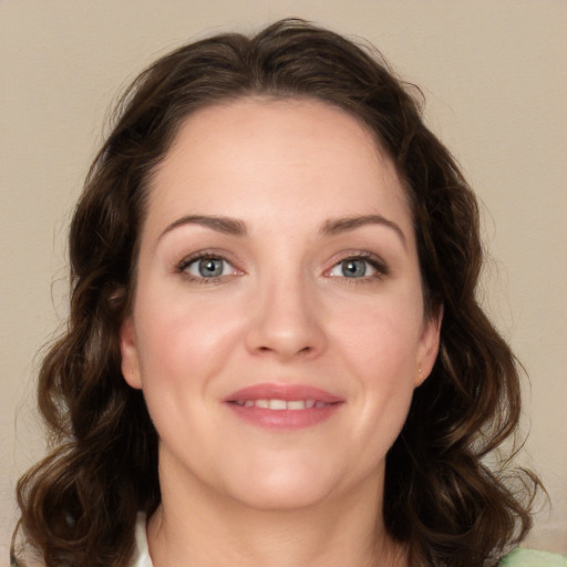 Joyful white young-adult female with medium  brown hair and green eyes