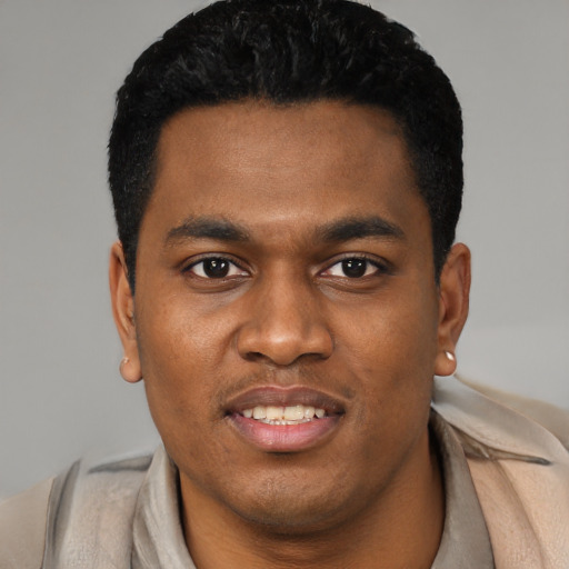 Joyful black young-adult male with short  black hair and brown eyes