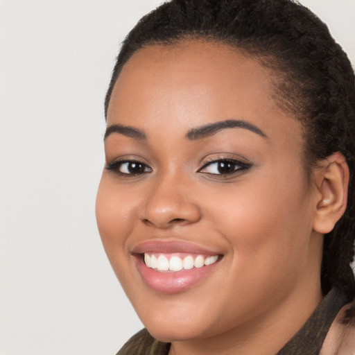 Joyful latino young-adult female with long  brown hair and brown eyes