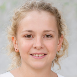 Joyful white child female with medium  brown hair and brown eyes