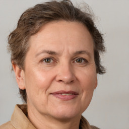 Joyful white adult female with medium  brown hair and grey eyes