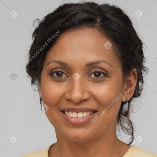 Joyful latino adult female with medium  brown hair and brown eyes