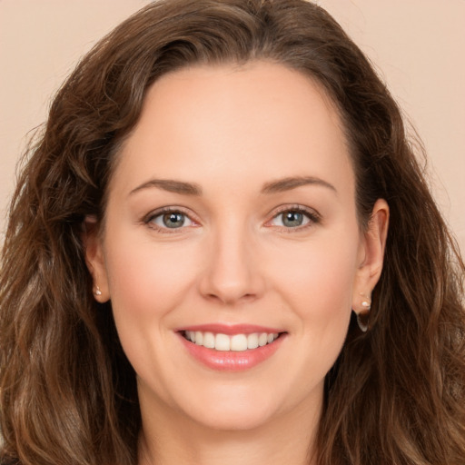 Joyful white young-adult female with long  brown hair and brown eyes