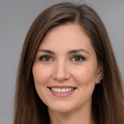 Joyful white young-adult female with long  brown hair and brown eyes