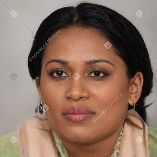 Joyful black young-adult female with long  brown hair and brown eyes