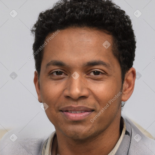 Joyful black young-adult male with short  black hair and brown eyes