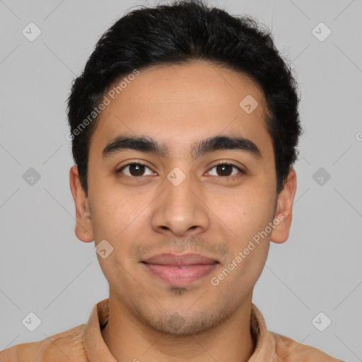 Joyful latino young-adult male with short  black hair and brown eyes