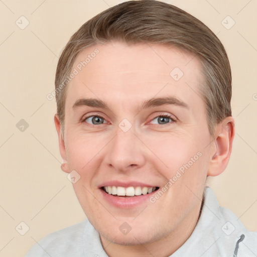 Joyful white young-adult male with short  brown hair and blue eyes